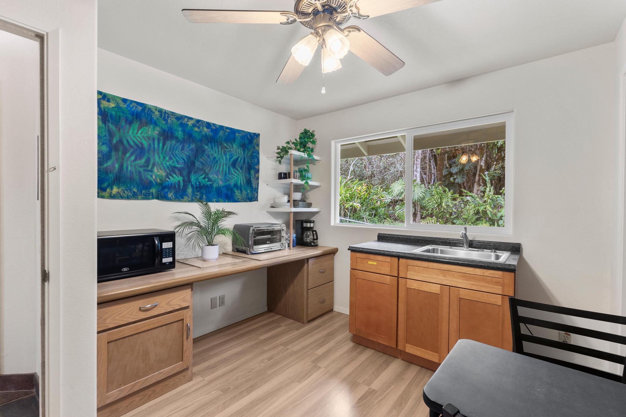 120 Opio Road Hilo, HI 96720 - Photo 15 of 30 a kitchen with stainless steel appliances granite countertop a stove a sink and a microwave