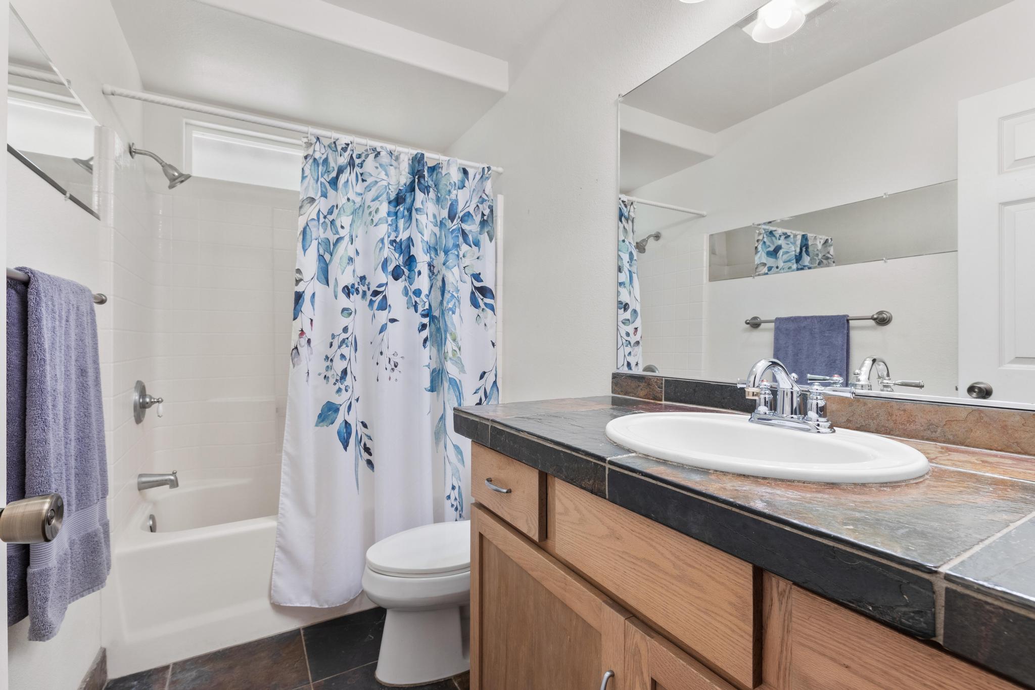 120 Opio Road Hilo, HI 96720 - Photo 20 of 30 a bathroom with a sink a toilet and a large mirror