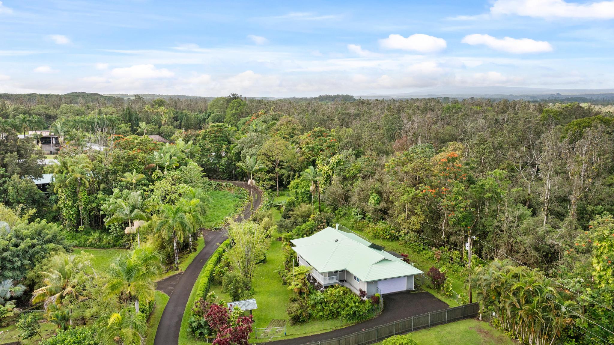 120 Opio Road Hilo, HI 96720 - Photo 2 of 30 an aerial view of residential houses with outdoor space and trees