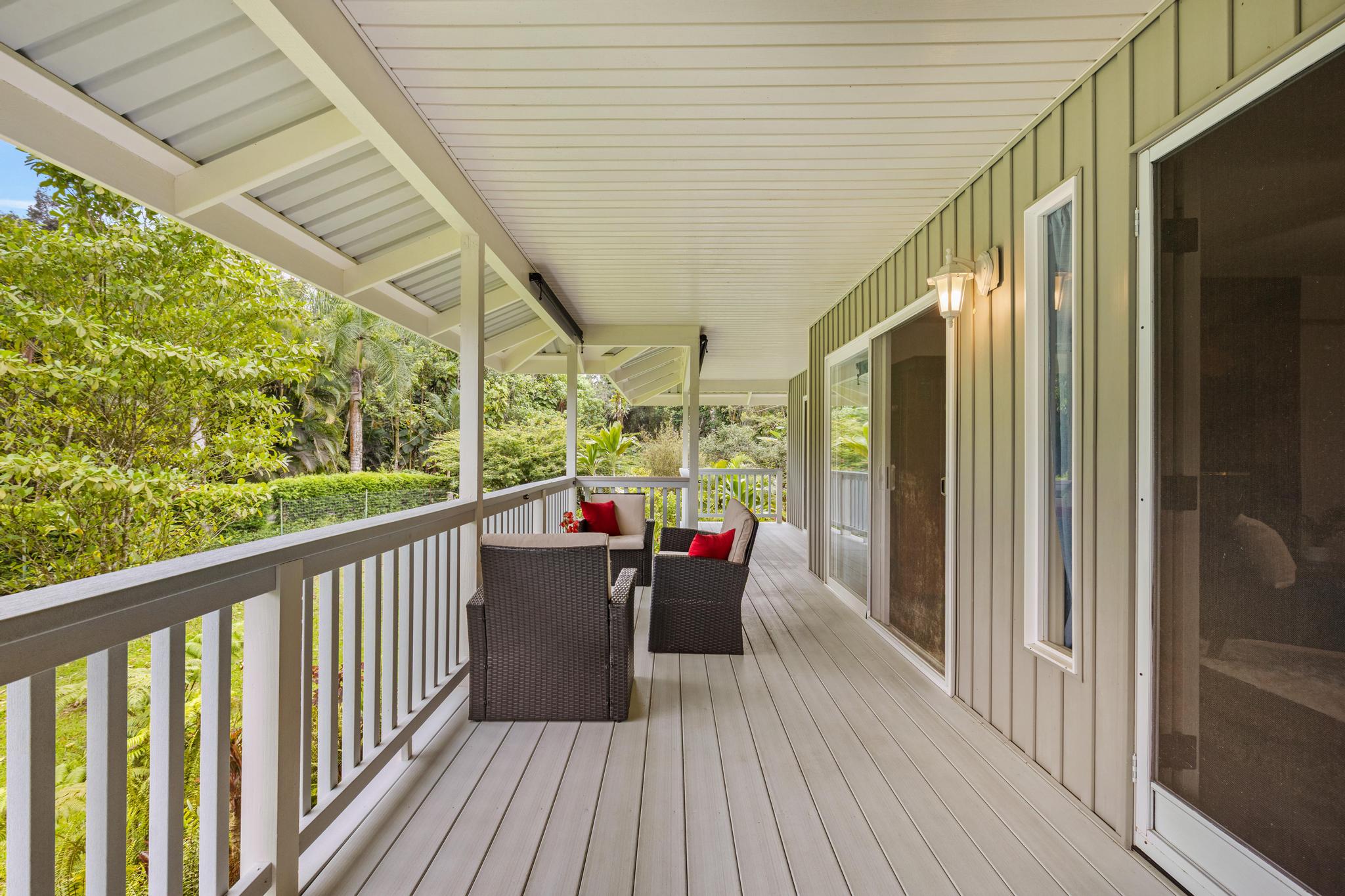 120 Opio Road Hilo, HI 96720 - Photo 22 of 30 a balcony with wooden floor table and chairs