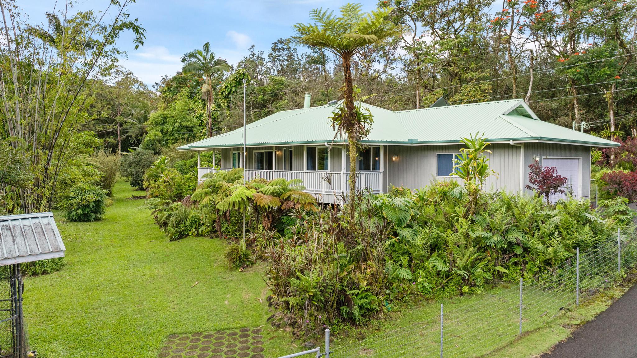 120 Opio Road Hilo, HI 96720 - Photo 23 of 30 a front view of a house with garden