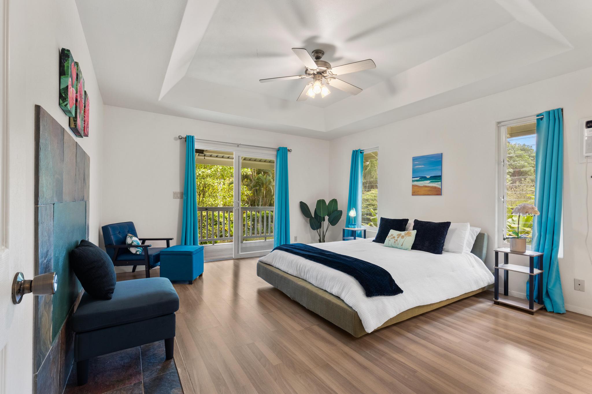 120 Opio Road Hilo, HI 96720 - Photo 8 of 30 a bedroom with a bed wooden floor and couch