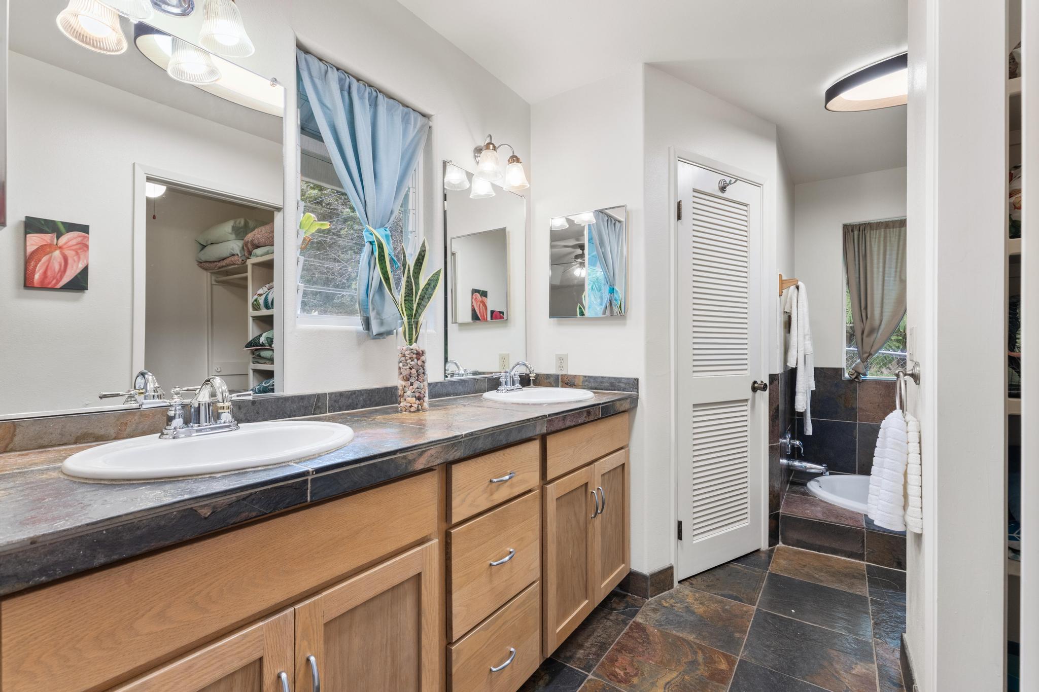 120 Opio Road Hilo, HI 96720 - Photo 10 of 30 a en suite bathroom with a double vanity sink a mirror and a shower