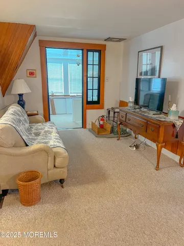 a bedroom with furniture and a large window