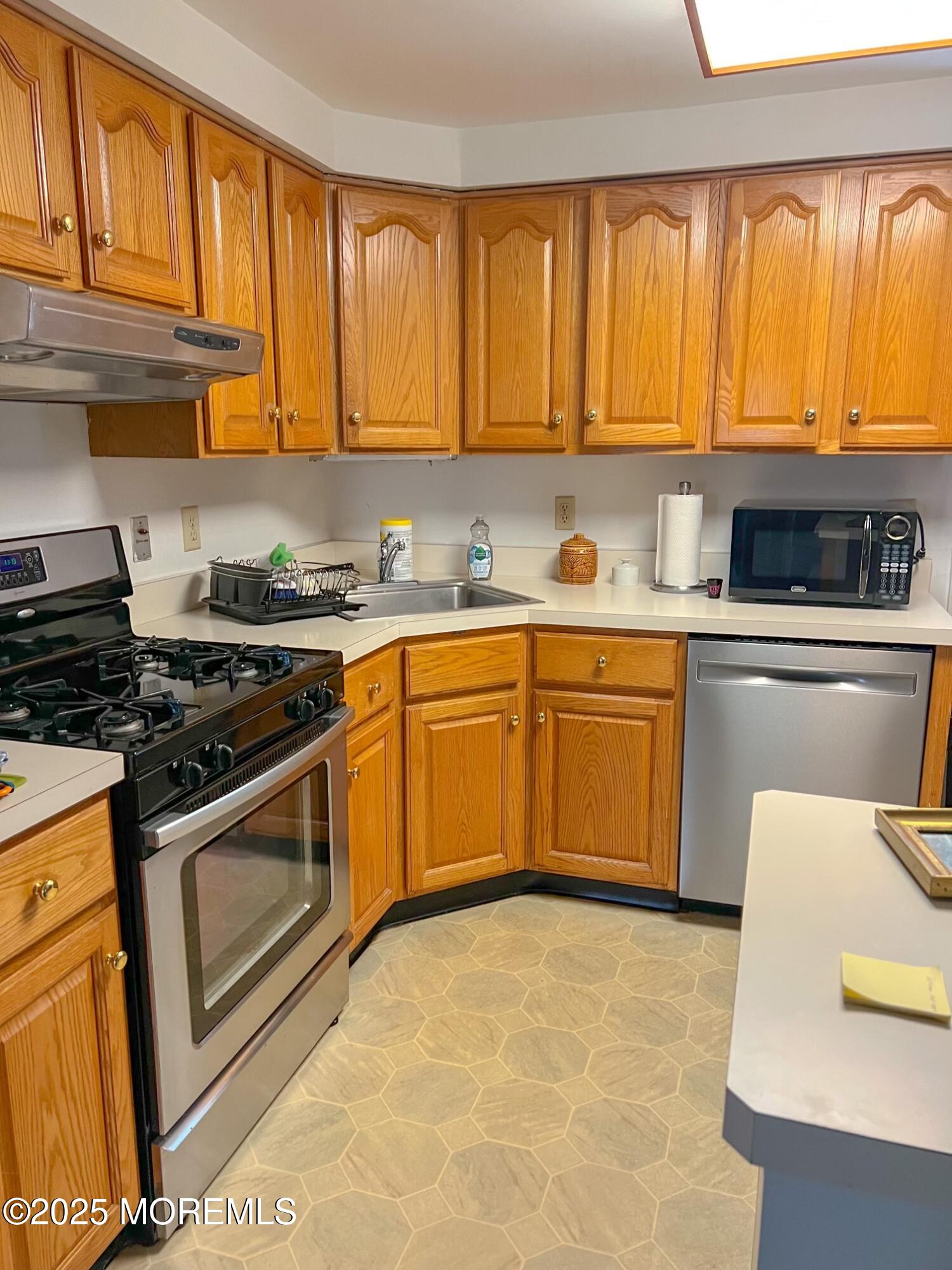 413 Morris Avenue Spring Lake, NJ 07762 - Photo 6 of 14 a kitchen with stainless steel appliances granite countertop a stove a sink dishwasher and a refrigerator