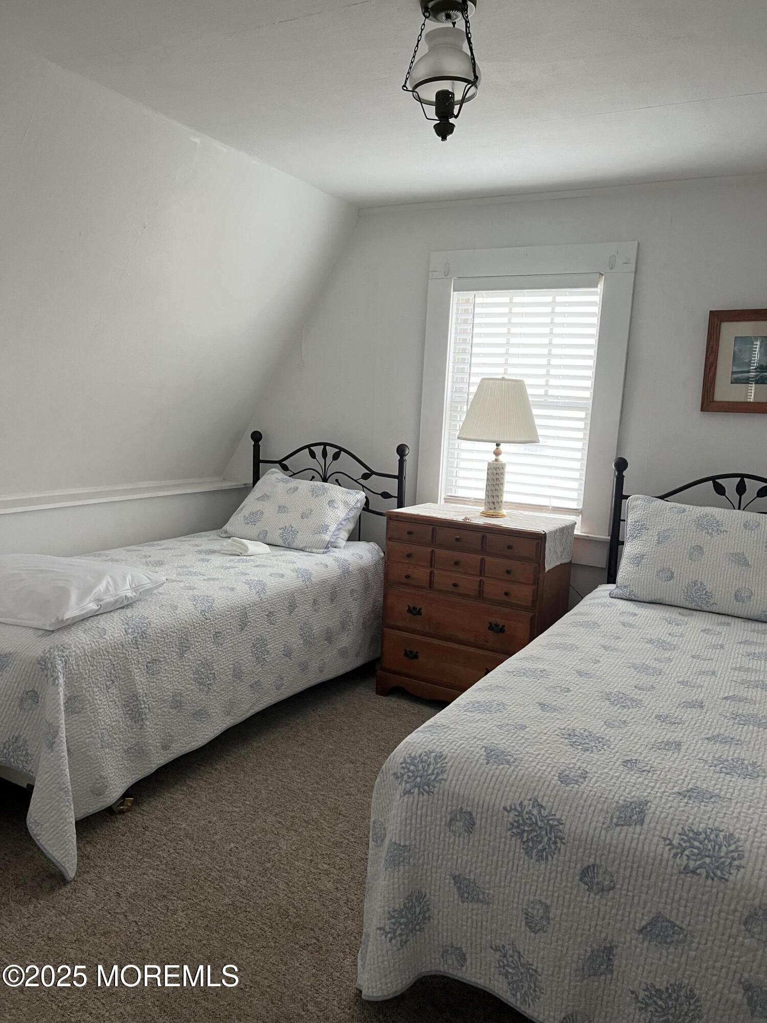 413 Morris Avenue Spring Lake, NJ 07762 - Photo 8 of 14 a bedroom with a bed and a dresser