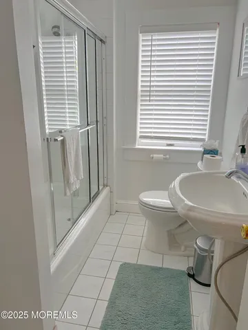 a bathroom with a sink a toilet and tub