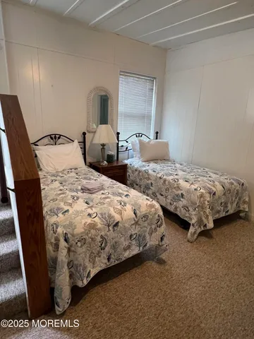 a bedroom with bed and window