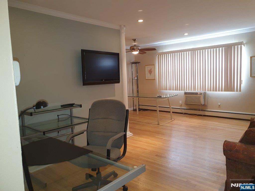 180 Atlantic Street Paterson, NJ 07503 - Photo 3 of 7 a living room with furniture window and a flat screen tv