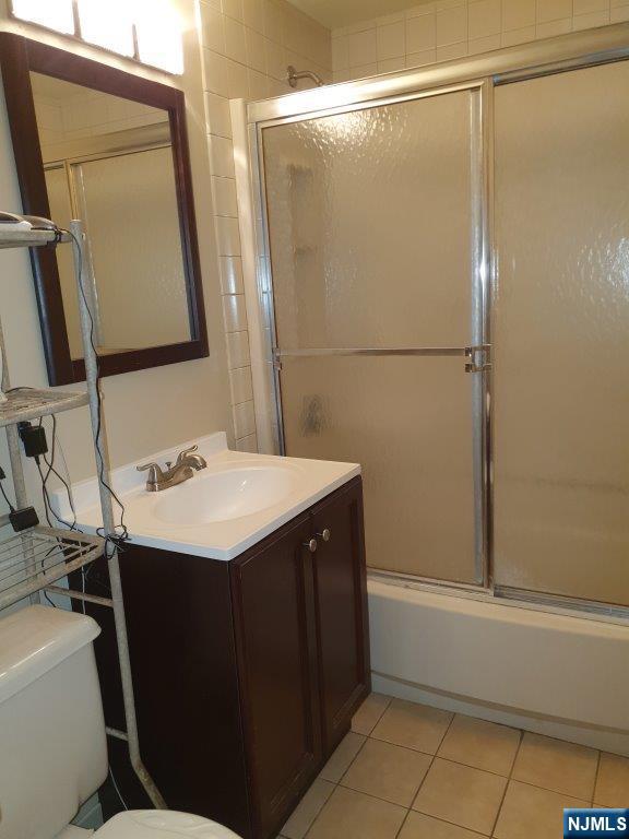 180 Atlantic Street Paterson, NJ 07503 - Photo 5 of 7 a bathroom with a sink and mirror