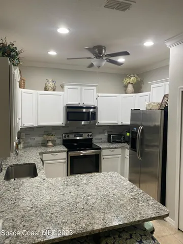 a kitchen with a stove a sink and a refrigerator