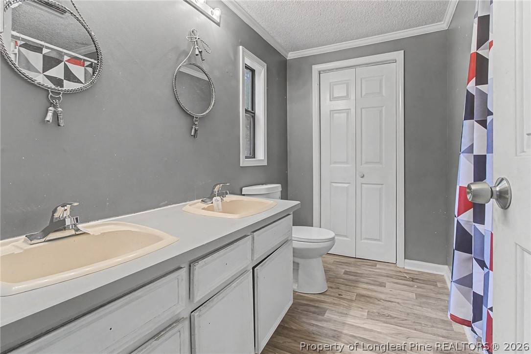 1512 Seabrook School Road Fayetteville, NC 28312 - Photo 17 of 30 a bathroom with a double vanity sink and a mirror