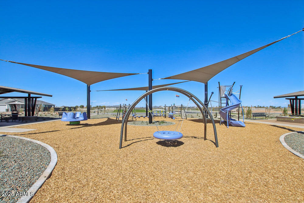 15708 West Camden Avenue Waddell, AZ 85355 - Photo 6 of 13 a view of a swimming pool with a lounge chair