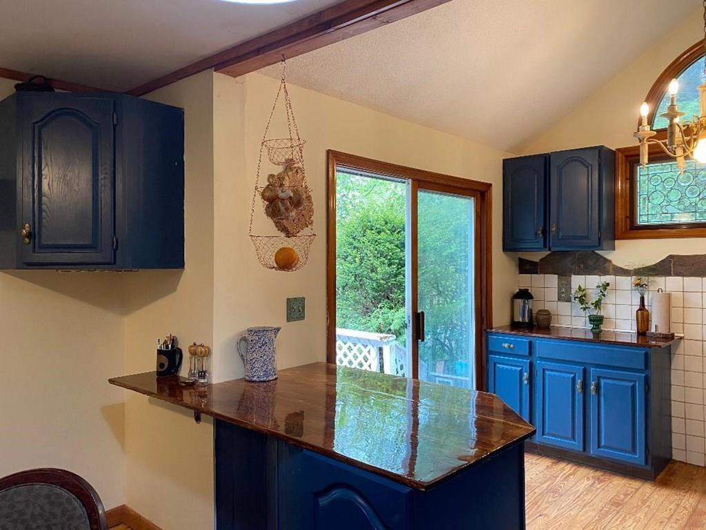 46 Littleville Road Huntington, MA 01050 - Photo 15 of 19 a kitchen with granite countertop a sink a stove and wooden cabinets