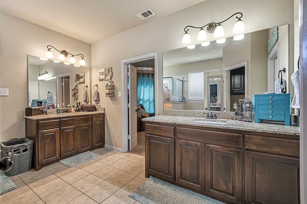 3206 Meadow Ridge Drive Midlothian, TX 76065 - Photo 21 of 37 a spacious bathroom with a granite countertop sink a mirror and a shower