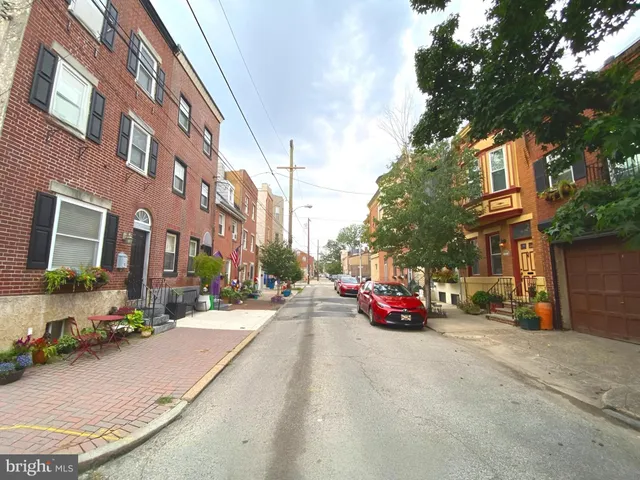 a row of palm trees in front of a building