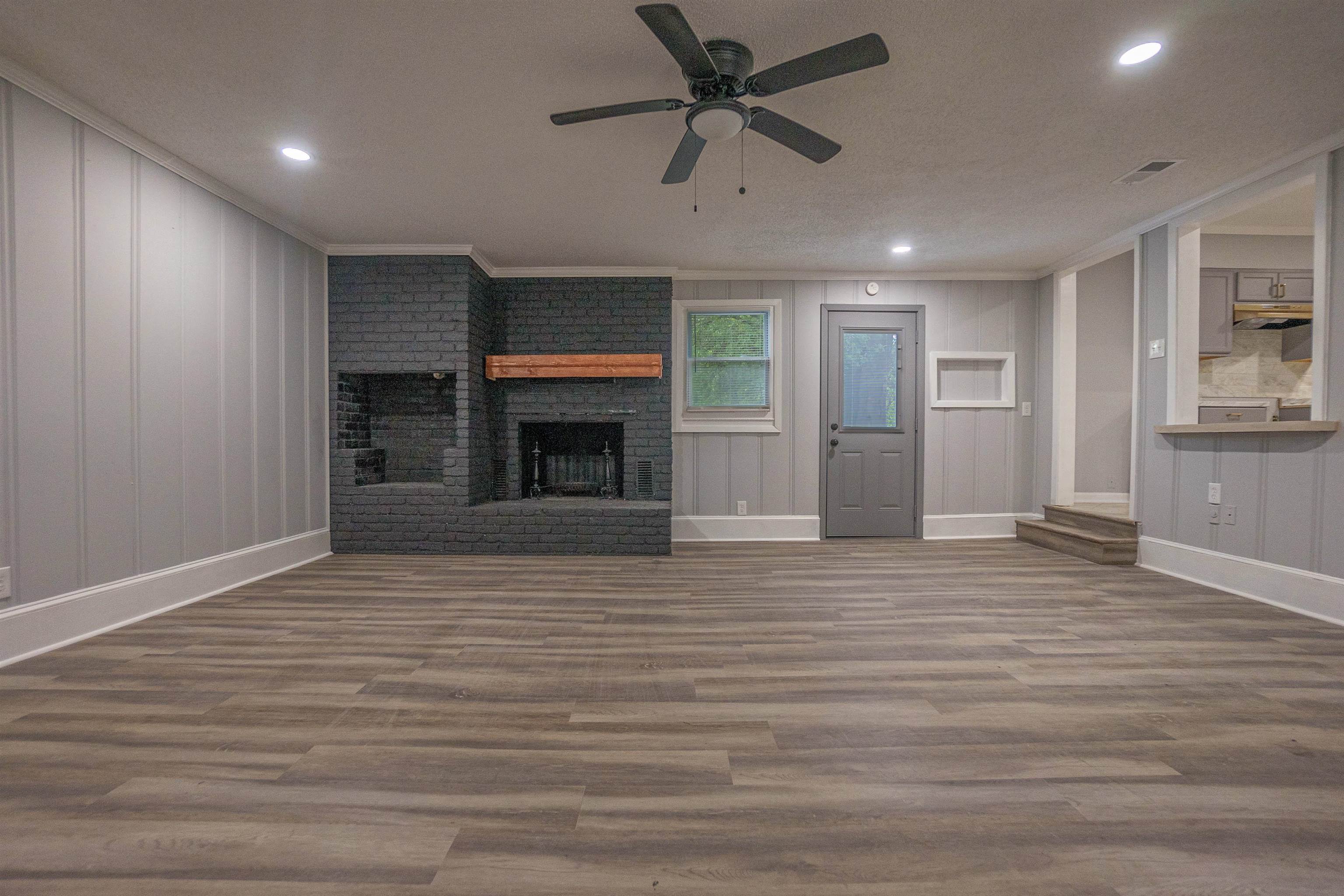 1011 Haledale Road Memphis, TN 38116 - Photo 17 of 25 a view of empty room with wooden floor and fireplace
