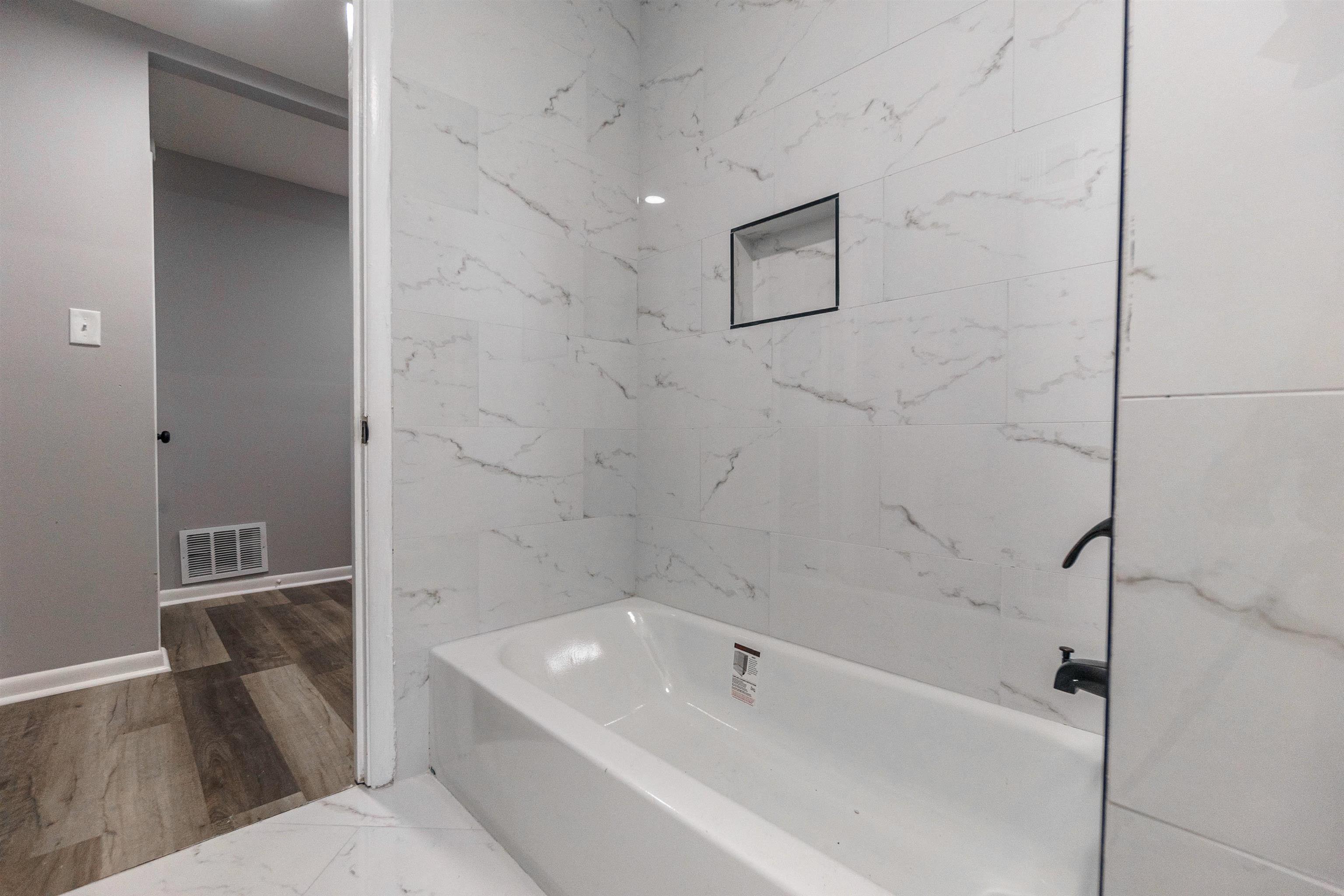 1011 Haledale Road Memphis, TN 38116 - Photo 21 of 25 a bathroom with a bathtub and shower