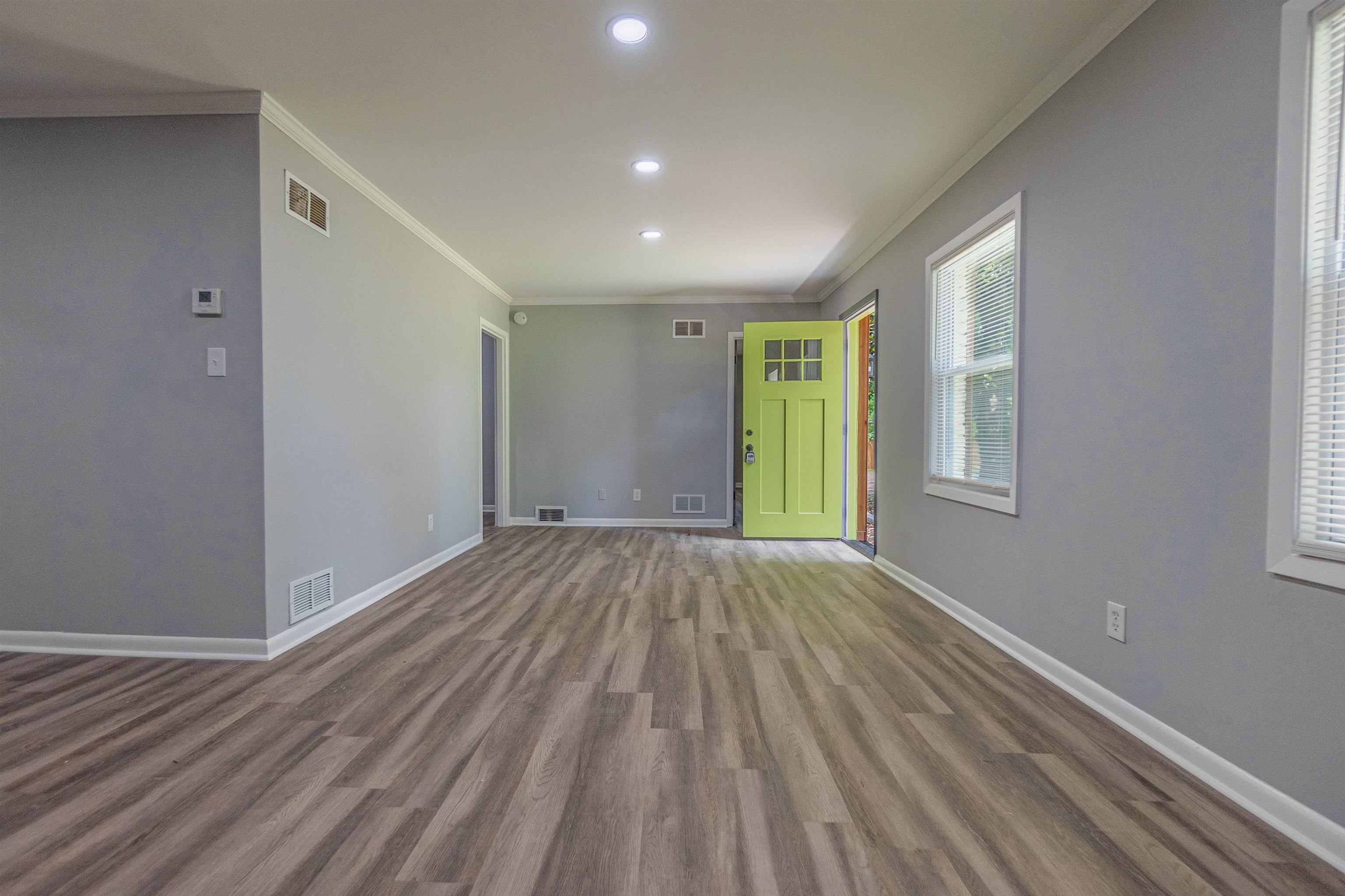1011 Haledale Road Memphis, TN 38116 - Photo 4 of 25 a view of an empty room with wooden floor and a window