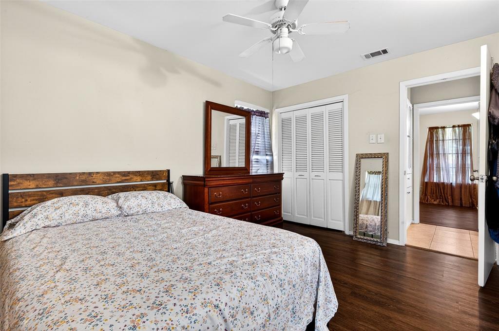 2718 Ridgewood Street Irving, TX 75062 - Photo 20 of 25 Bedroom featuring wood-finish flooring, a ceiling fan, and painted walls