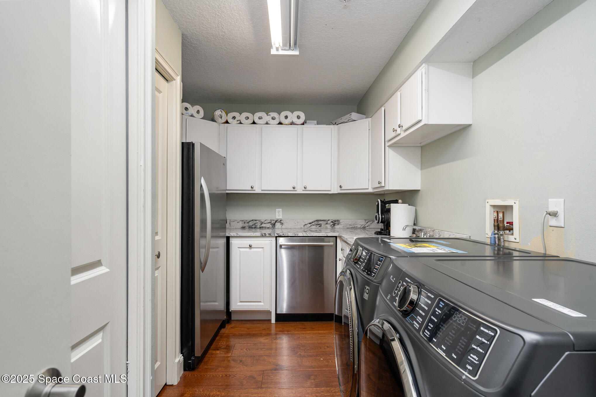 29 Riverside Drive, Unit 203 Cocoa, FL 32922 - Photo 12 of 33 a kitchen with stainless steel appliances granite countertop a sink a stove a refrigerator and island