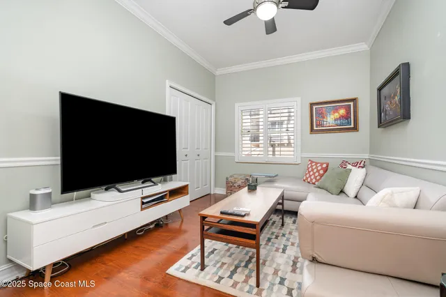 a living room with furniture and wooden floor