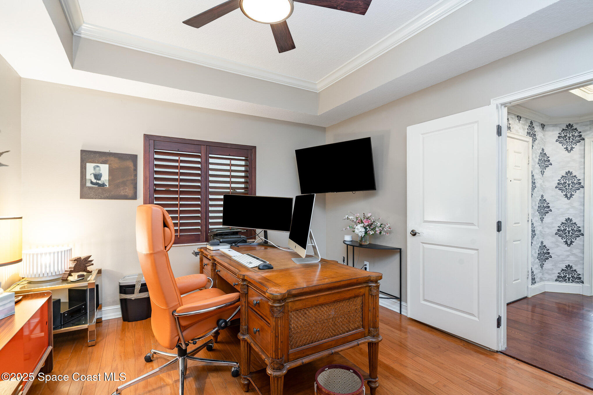 29 Riverside Drive, Unit 203 Cocoa, FL 32922 - Photo 17 of 33 a view of a workspace with furniture and a flat screen tv