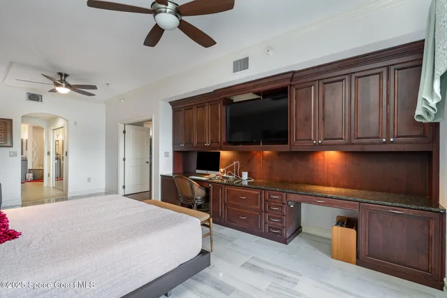 a bedroom with a bed and a lamp