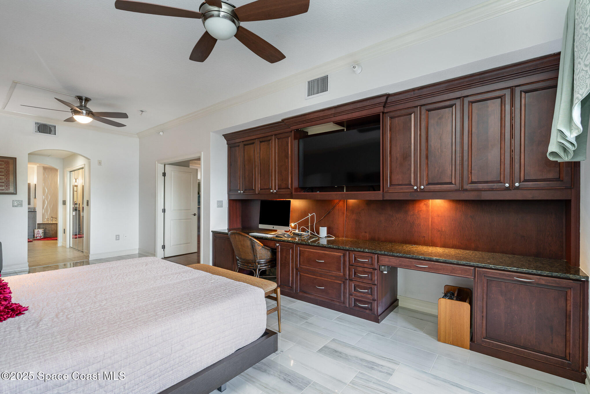 29 Riverside Drive, Unit 203 Cocoa, FL 32922 - Photo 20 of 33 a bed room with a bed and a television