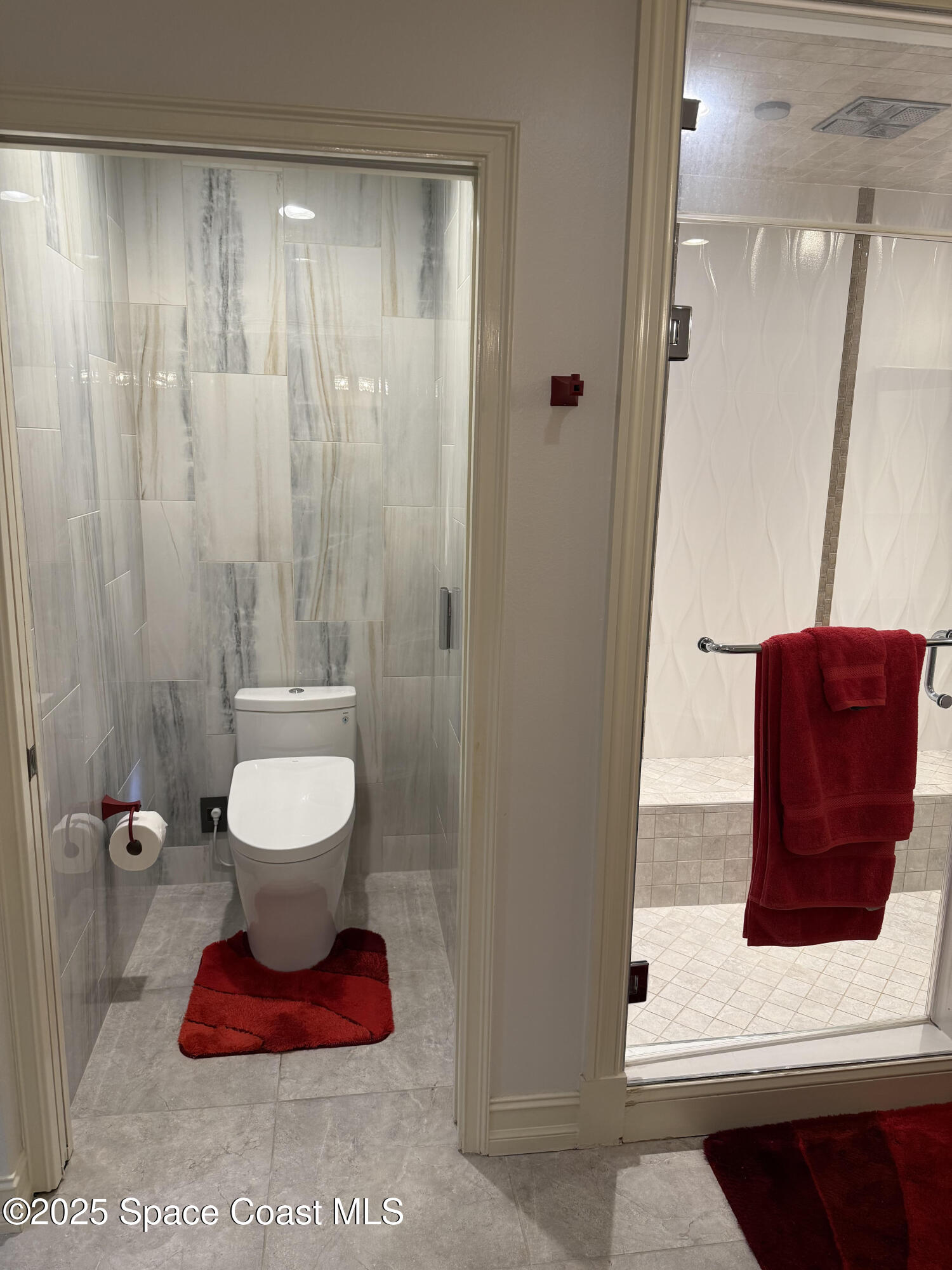 29 Riverside Drive, Unit 203 Cocoa, FL 32922 - Photo 23 of 33 a bathroom with a toilet and a shower