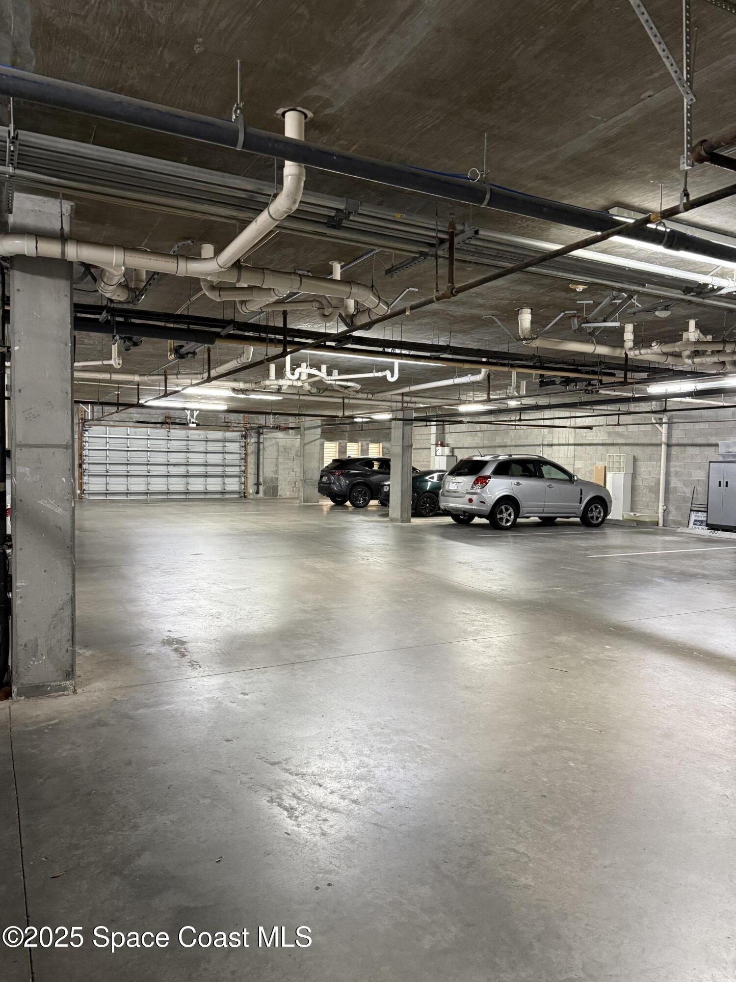 29 Riverside Drive, Unit 203 Cocoa, FL 32922 - Photo 29 of 33 a view of parking garage with cars