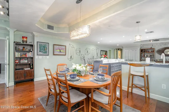 a dining table with chairs and kitchen view