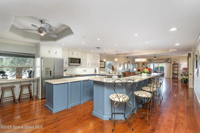 a large kitchen with stainless steel appliances kitchen island a large counter top