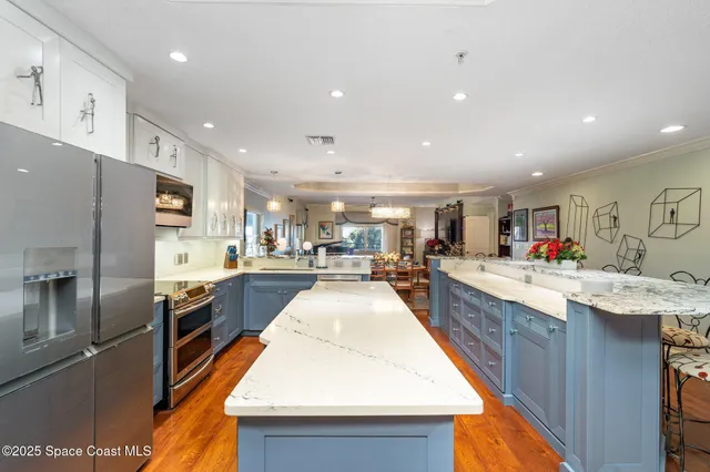a kitchen with stainless steel appliances kitchen island granite countertop a sink and cabinets