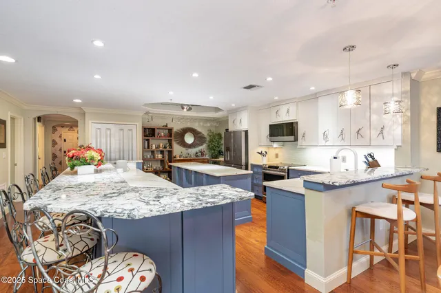 a kitchen with granite countertop sink and a refrigerator