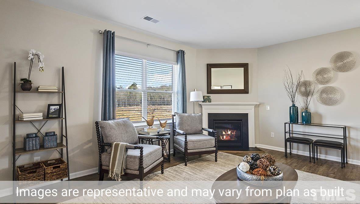 1006 Broadlands Way Graham, NC 27253 - Photo 12 of 25 a living room with furniture a fireplace and next to a window