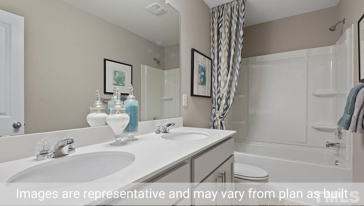 1006 Broadlands Way Graham, NC 27253 - Photo 16 of 25 a bathroom with a sink a toilet and shower