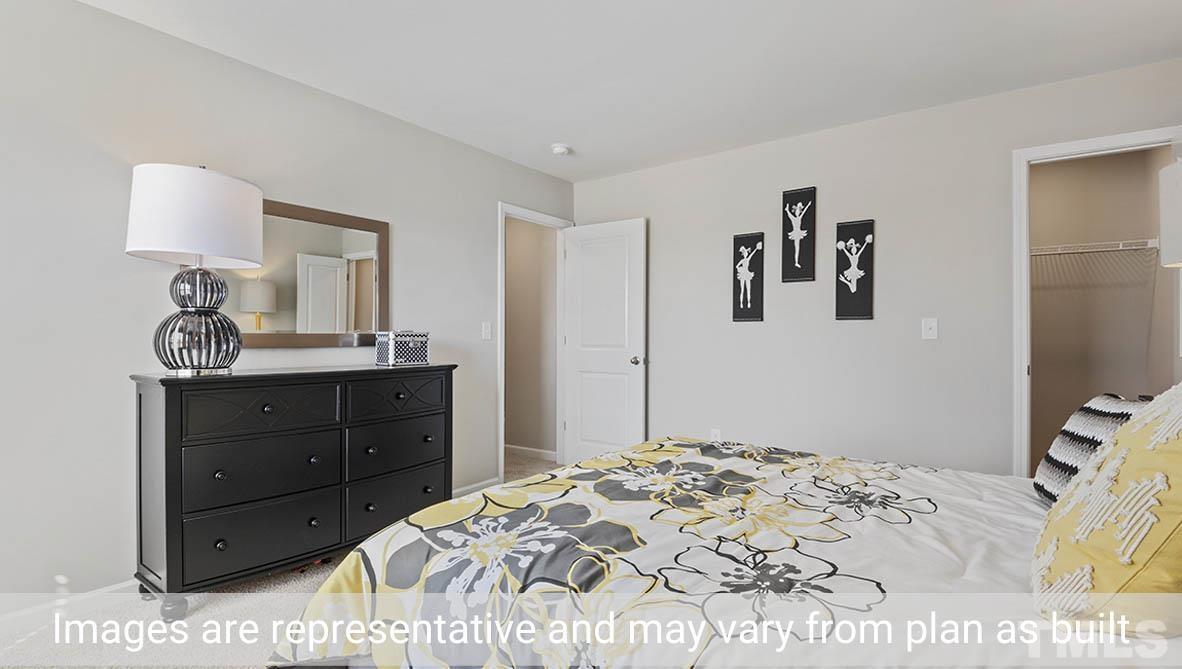 1006 Broadlands Way Graham, NC 27253 - Photo 19 of 25 a bedroom with a bed and a dresser in it