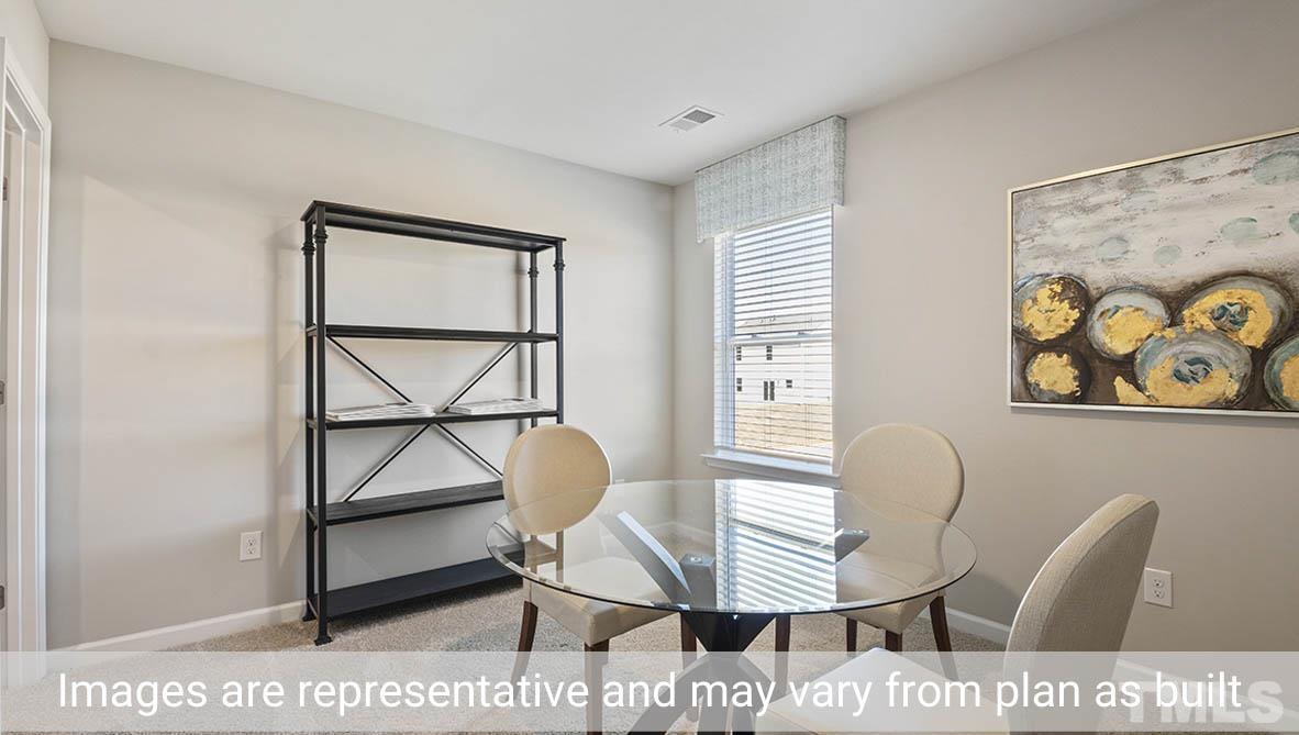 1006 Broadlands Way Graham, NC 27253 - Photo 22 of 25 a view of a dining room with furniture and a window