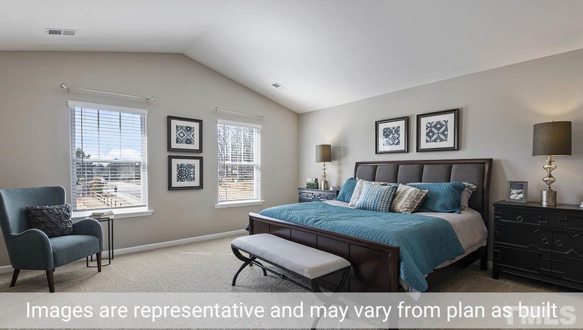 1006 Broadlands Way Graham, NC 27253 - Photo 23 of 25 a bedroom with a bed a couch and a window