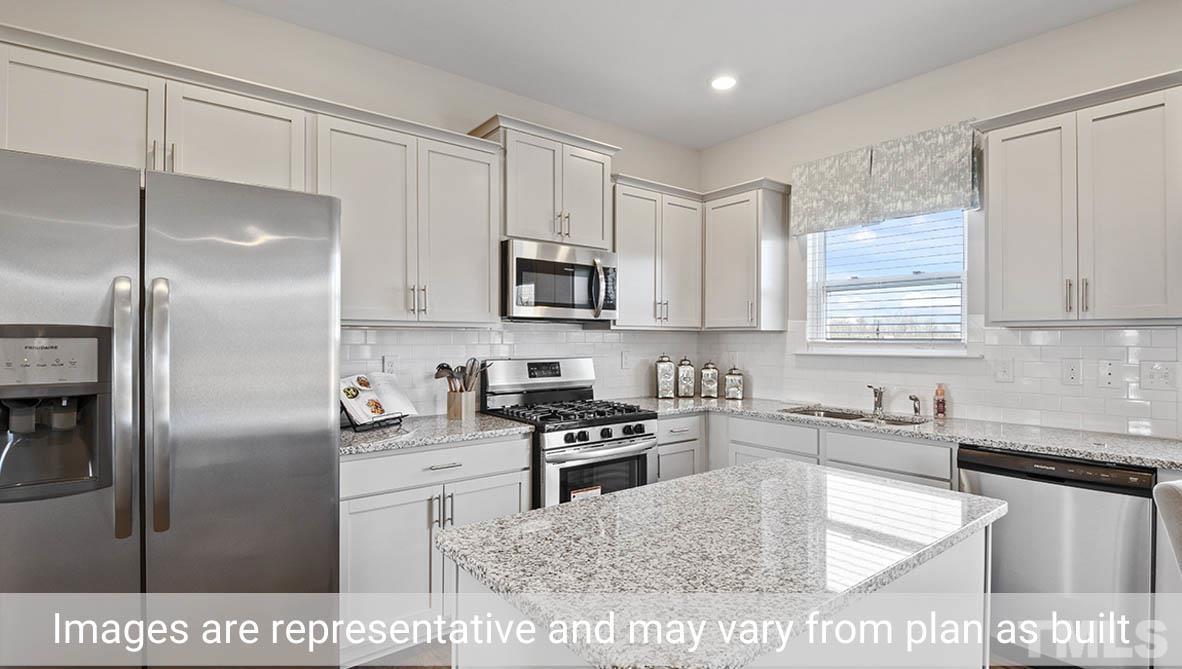 1006 Broadlands Way Graham, NC 27253 - Photo 9 of 25 a kitchen with stainless steel appliances granite countertop a sink a stove a refrigerator a washer dryer and cabinets