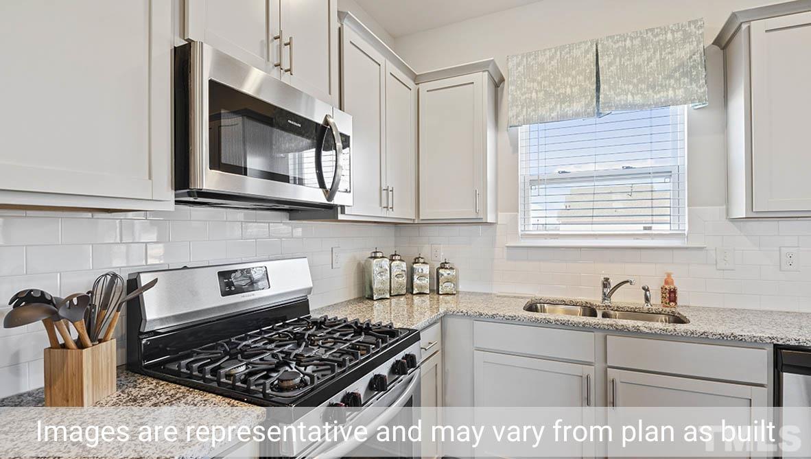 1006 Broadlands Way Graham, NC 27253 - Photo 10 of 25 a kitchen with stainless steel appliances granite countertop a stove and a microwave