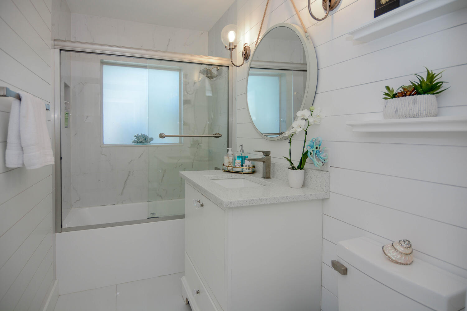3396 Pebble Place Jupiter, FL 33469 - Photo 23 of 24 a bathroom with a sink a mirror and vanity