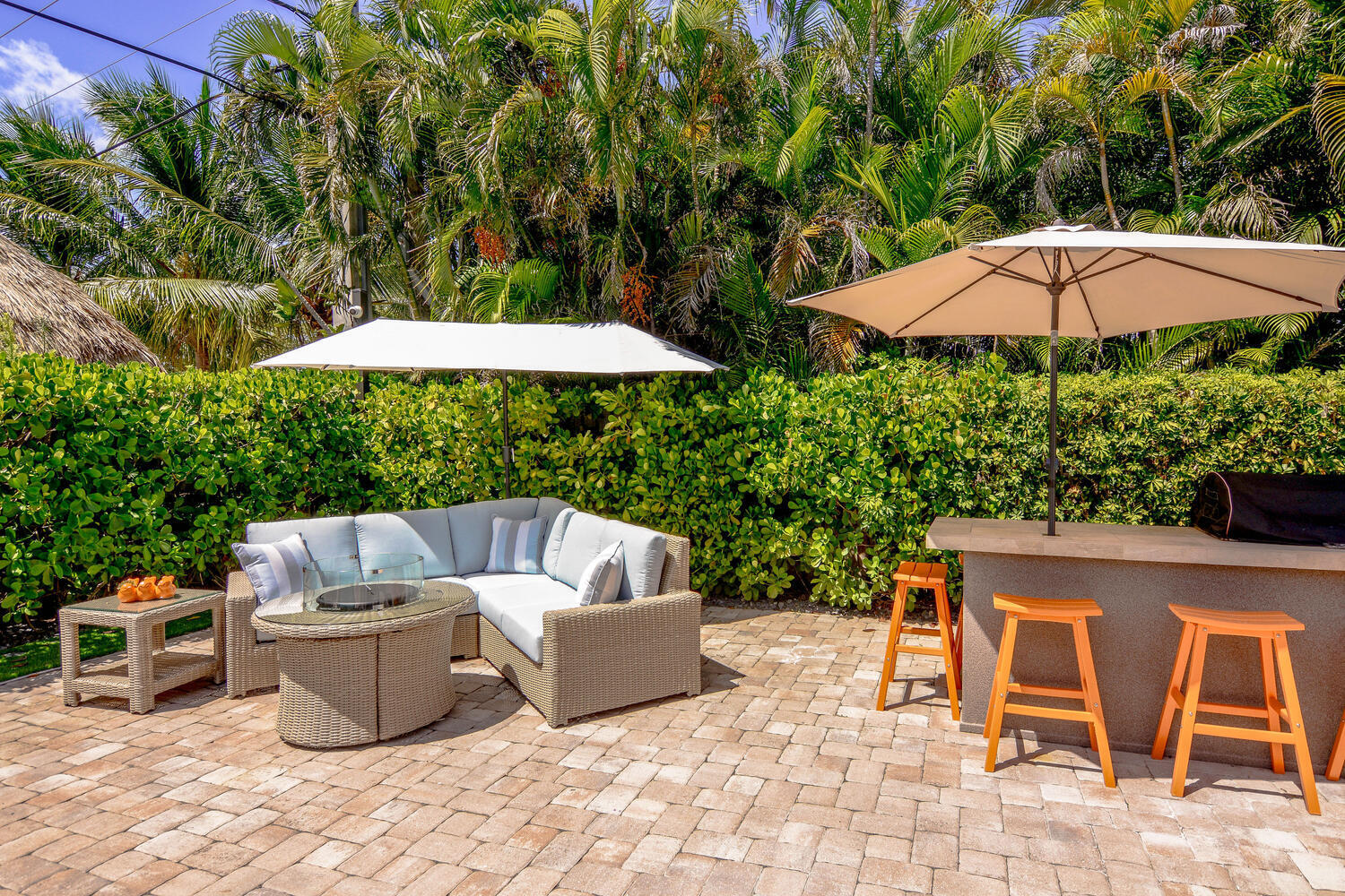 3396 Pebble Place Jupiter, FL 33469 - Photo 3 of 24 a patio with patio a table and chairs under an umbrella