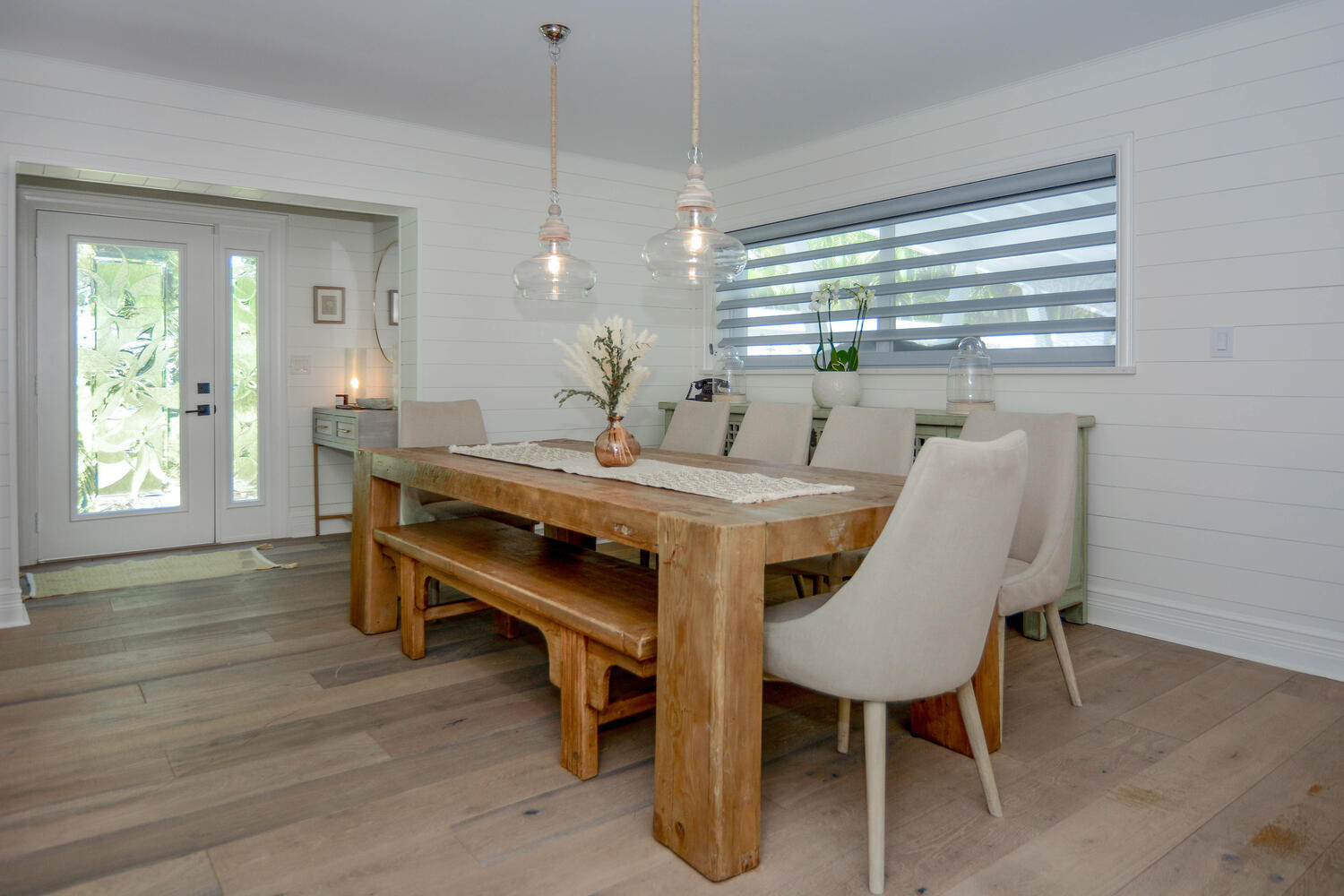 3396 Pebble Place Jupiter, FL 33469 - Photo 10 of 24 a view of a dining room with furniture window and wooden floor