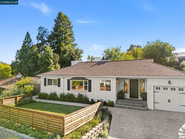 a front view of a house with a garden