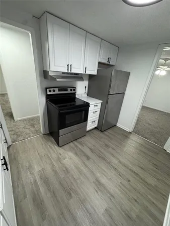 a kitchen with wooden cabinets and a stove