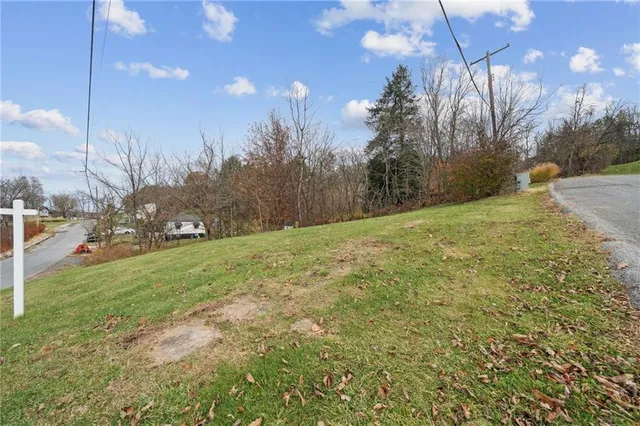 a yard with a house in the background