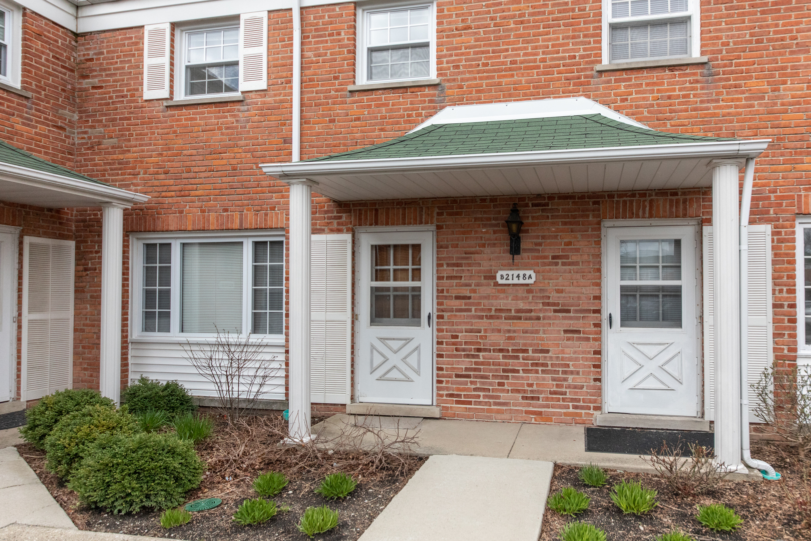 2148 Rugen Road, Unit B Glenview, IL 60026 - Photo 1 of 23 a front view of a house with garden