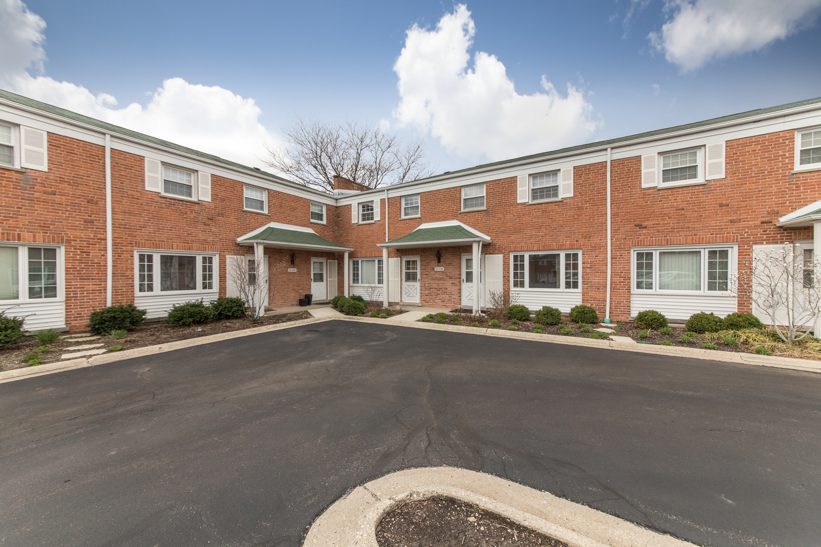 2148 Rugen Road, Unit B Glenview, IL 60026 - Photo 2 of 23 a front view of a building with a road